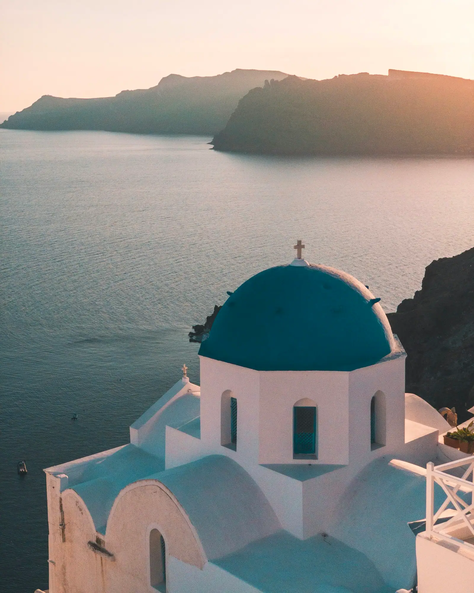 Whitewashed Cycladic village above the Santorini caldera at sunset