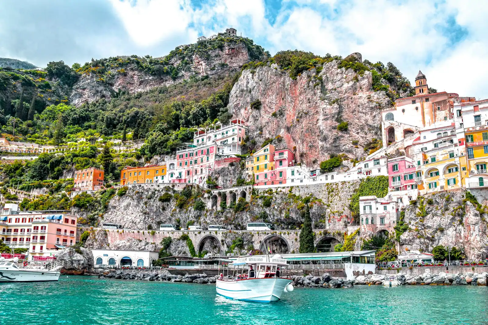 Pastel houses of an Amalfi coast village seen from the water
